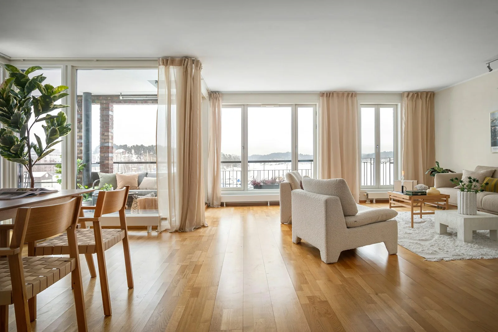 A contemporary living room with warm natural materials and generous light